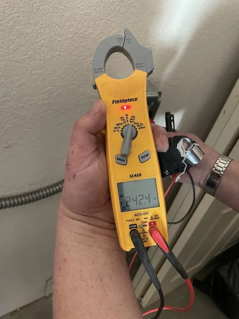 Voltage testing with clamp meter during Recessed Lighting Installation in Brookhaven